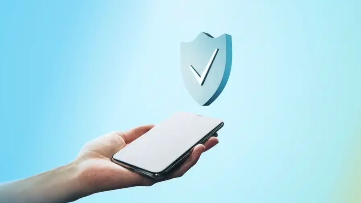 A phone being held with a checkmark hovering above it.