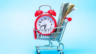 Red Retro Alarm Clock And Dollar Bills In Shopping Cart