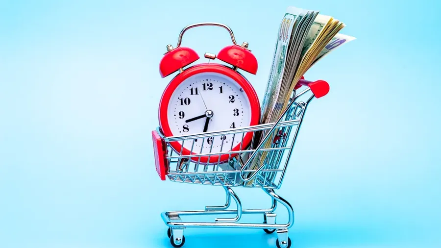 Red Retro Alarm Clock And Dollar Bills In Shopping Cart