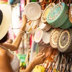 Woman In Hat Is Coming To Street Market And Choosing