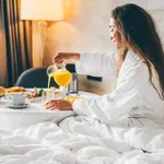 Woman Eating Breakfast In The Hotel Room. Room Service Breakfast