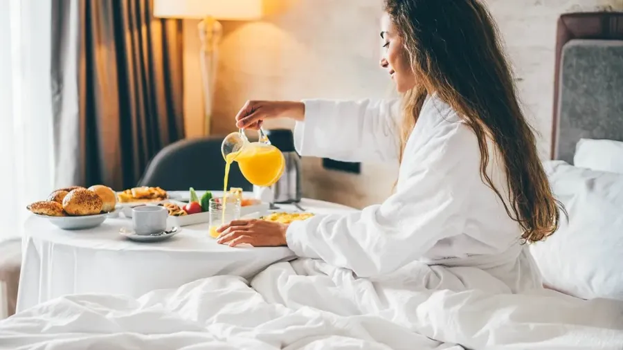 Woman Eating Breakfast In The Hotel Room. Room Service Breakfast