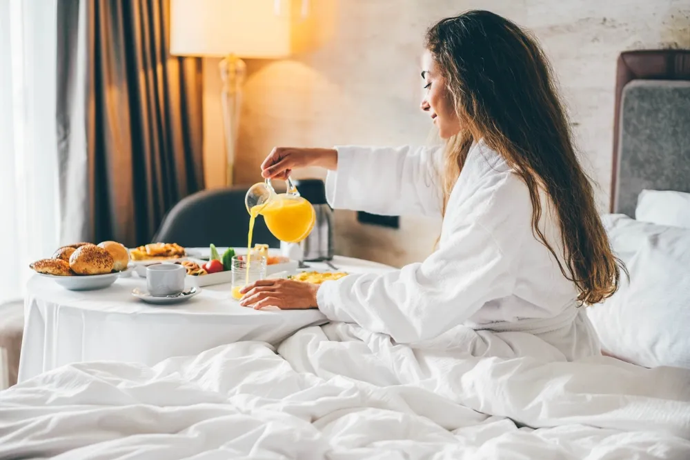 Woman Eating Breakfast In The Hotel Room. Room Service Breakfast