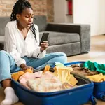 Emotional Black Woman Staring At Smartphone Screen In Terror Feeling