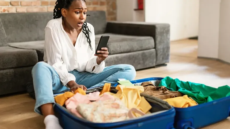 Emotional Black Woman Staring At Smartphone Screen In Terror Feeling