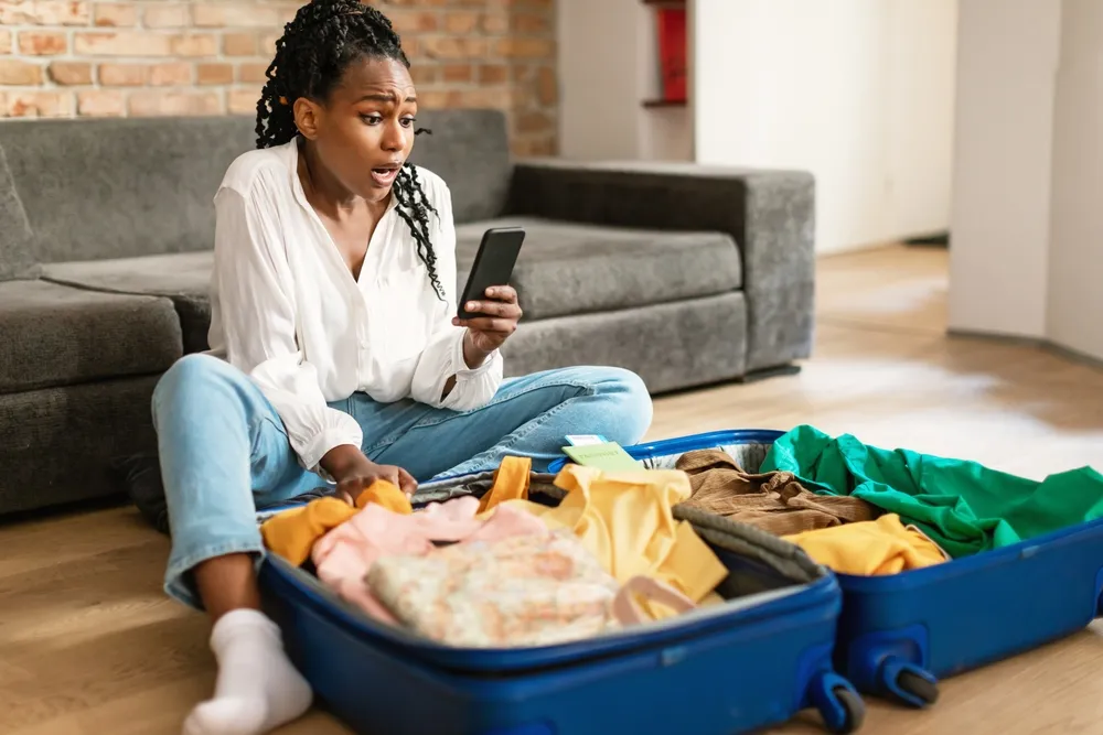Emotional Black Woman Staring At Smartphone Screen In Terror Feeling