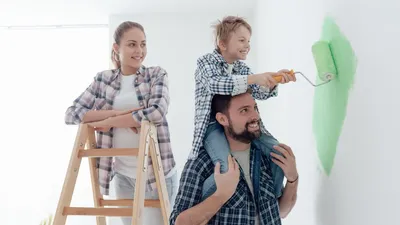 Happy Family Renovating Their New Home The Father Is Piggybacking