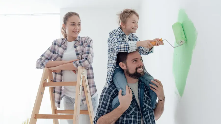 Happy Family Renovating Their New Home The Father Is Piggybacking