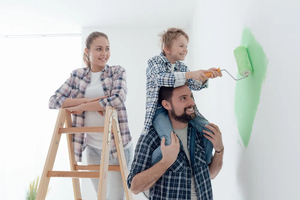 Happy Family Renovating Their New Home The Father Is Piggybacking