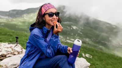 Traveler Woman Have Lunch On Nature In Mountains. Tea And