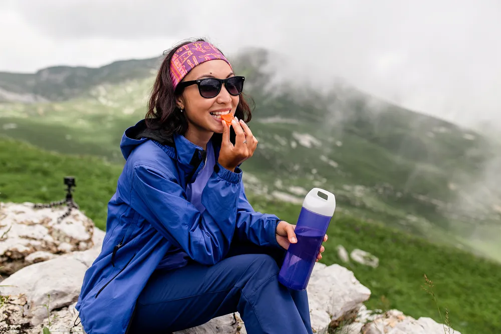 Traveler Woman Have Lunch On Nature In Mountains. Tea And